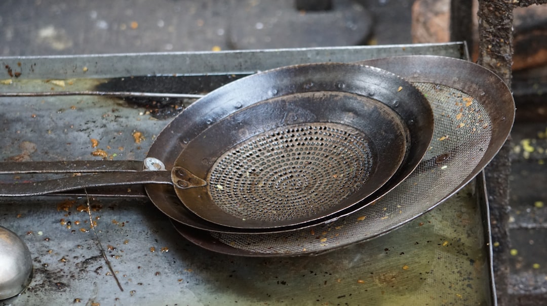 a metal strainer sitting on top of a metal tray