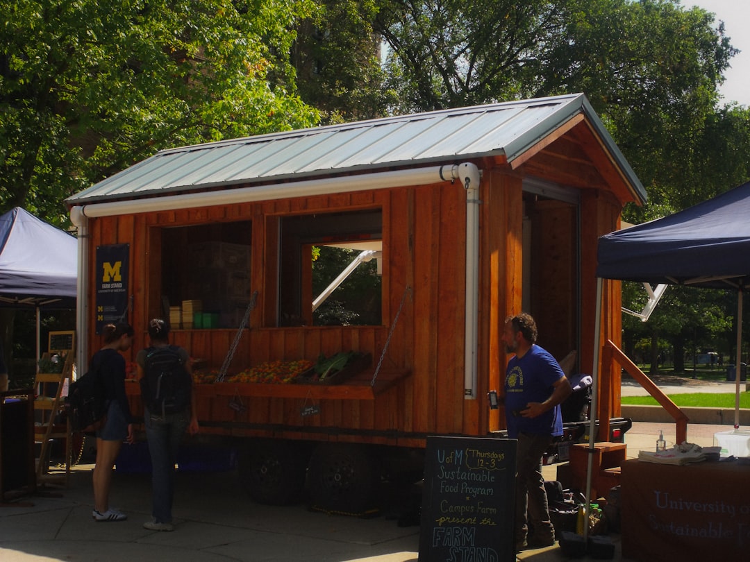 Wooden food stand with people browsing