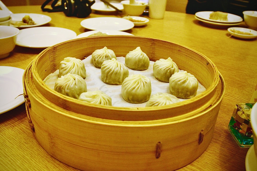 Steamed dumplings served in a bamboo steamer basket.