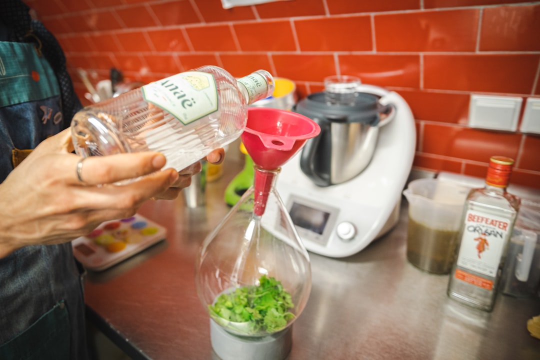 a person pours a drink into a blender
